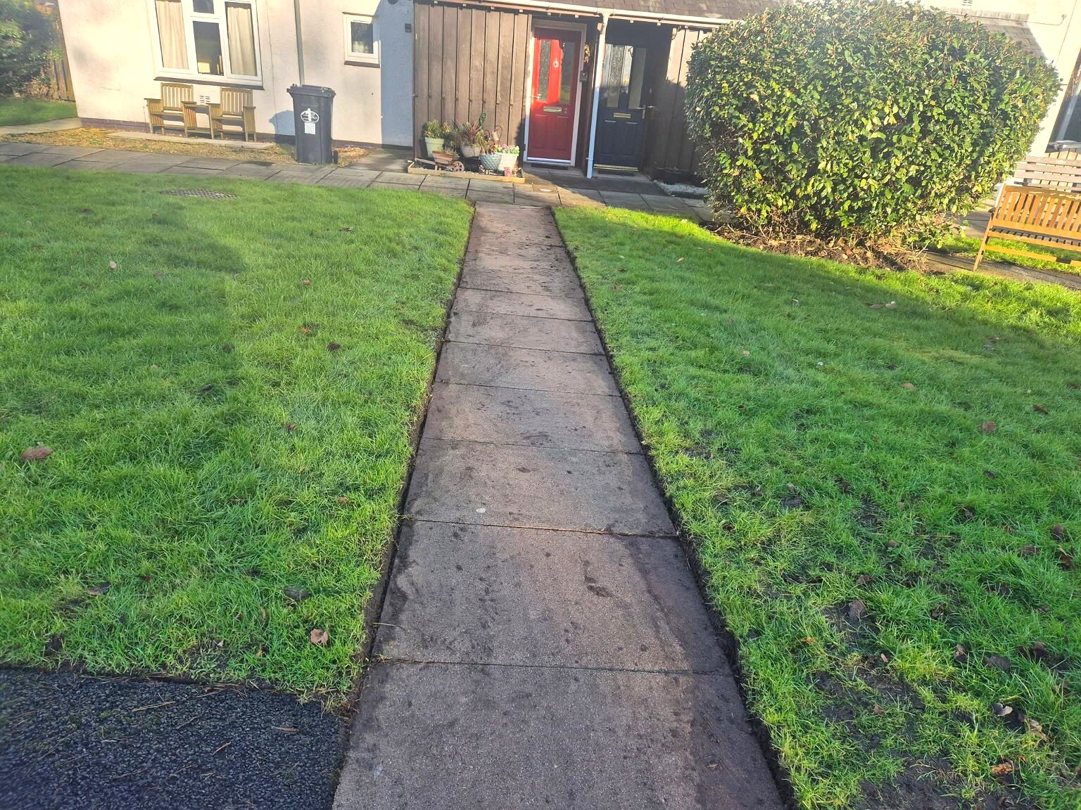 Neatly edged grass on both sides of a paved path